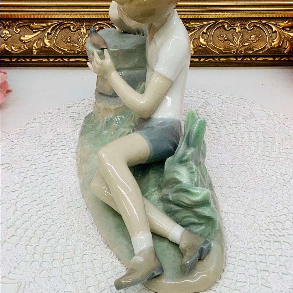Lladro Spanish porcelain boy admiring bird.